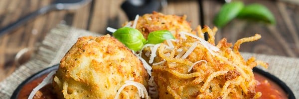 Spaghetti Balls with Meat Sauce! Spaghetti is combined with a cheesy mixture then formed into balls and fried until golden brown, then placed on top of a rich and hearty meat sauce.