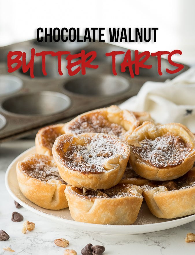 These Chocolate Walnut Butter Tarts are filled with a buttery brown sugar mixture and stuffed with chocolate and walnuts! This Canadian dessert is a must-make!